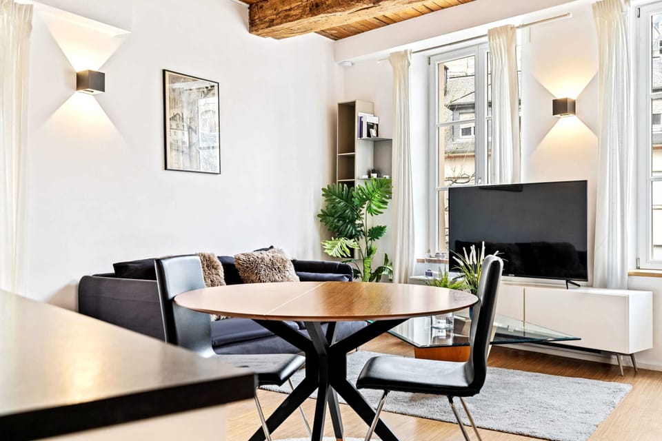 Inviting living and dining area with stylish furniture, large windows, and plenty of natural light.