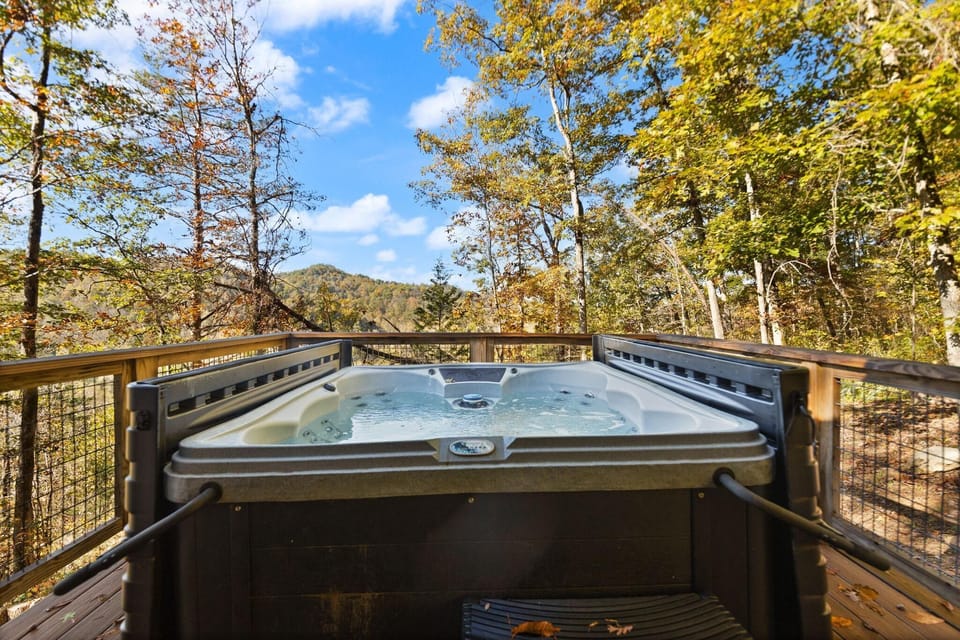Secluded outdoor hot tub surrounded by vast mountain and sky views