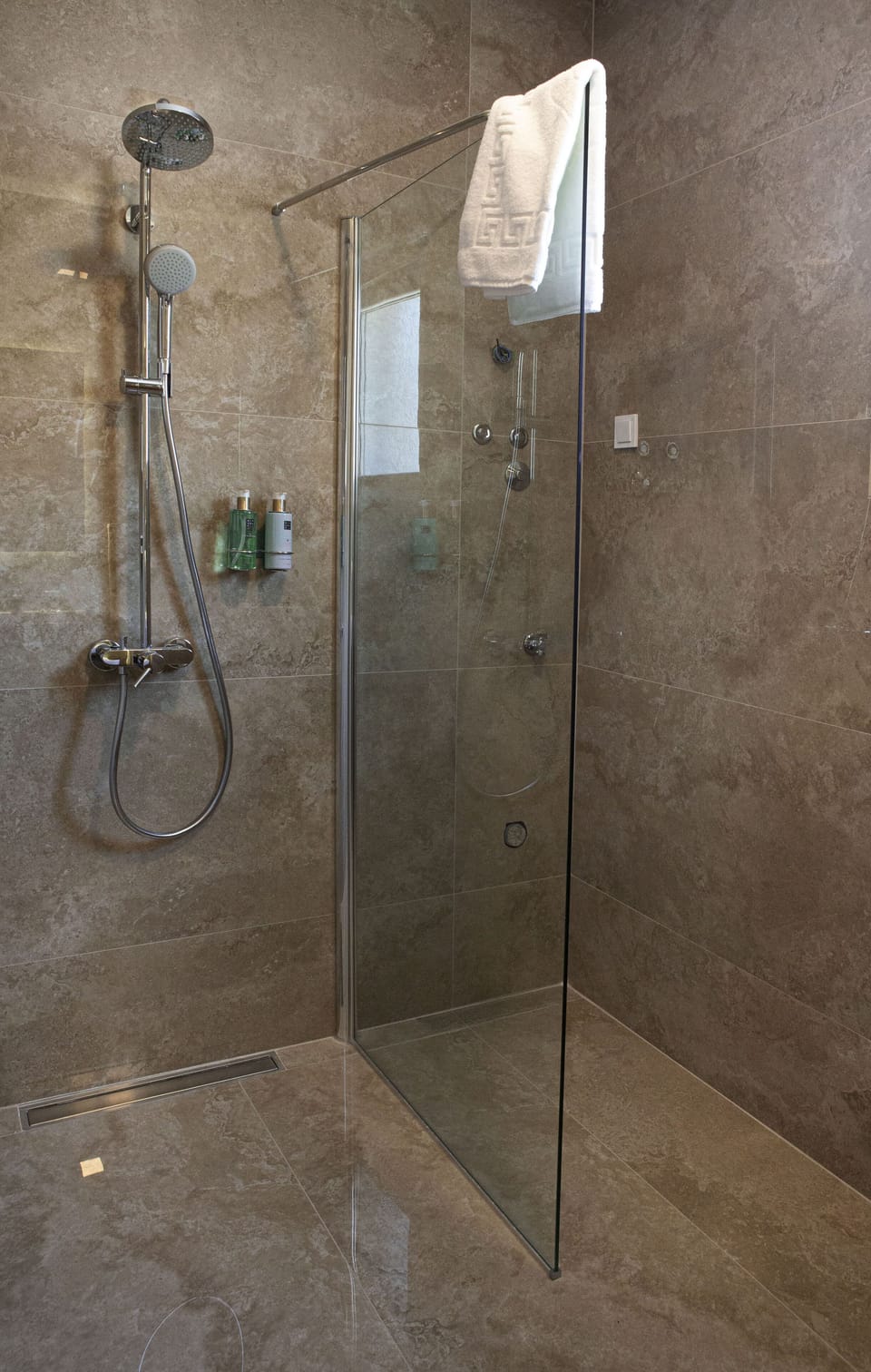 The bathroom provides a shower with hot water, toilet, cotton towels, soap. etc
