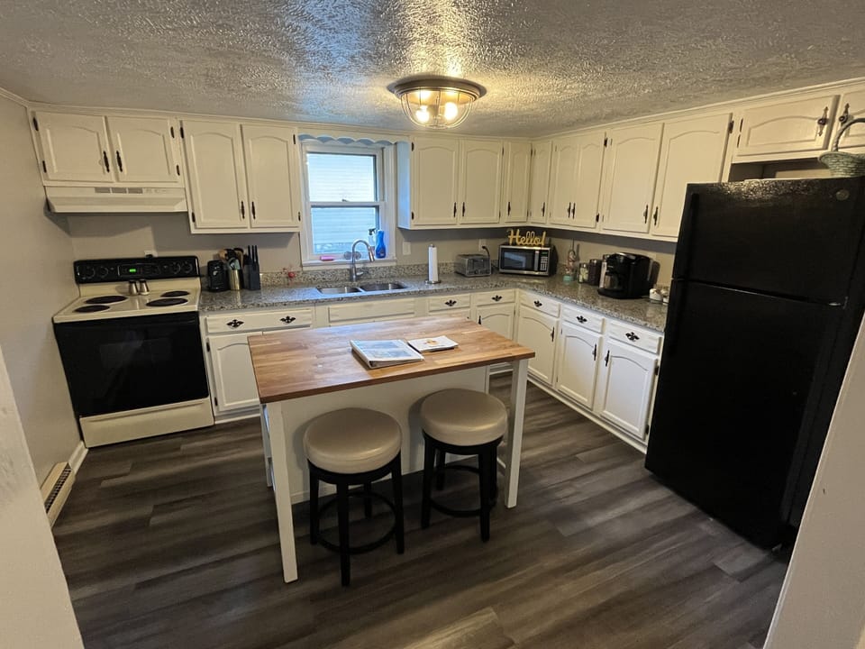 Granite countertops and island with extra seating.