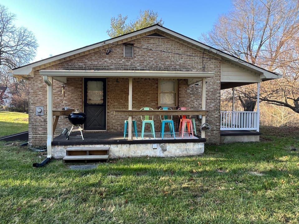 Side porch with seating and bbq grill.