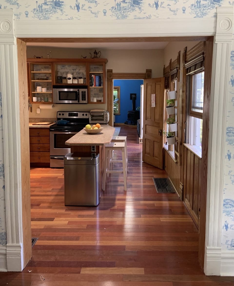 Looking into the kitchen (and further, the living room) from the dining room