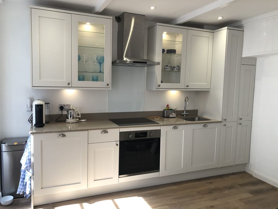 New kitchen with dishwasher and washing machine, microwave and coffee machine