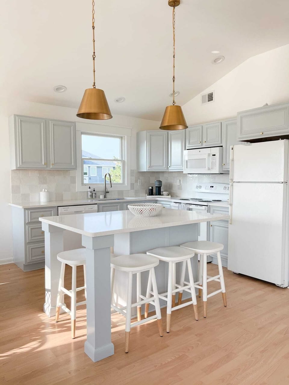 Kitchen with large island and 4 barstool seats.