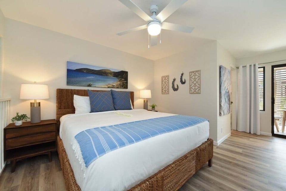 Relax in this serene king bedroom with island‑inspired décor, modern lighting, and a spacious, airy layout