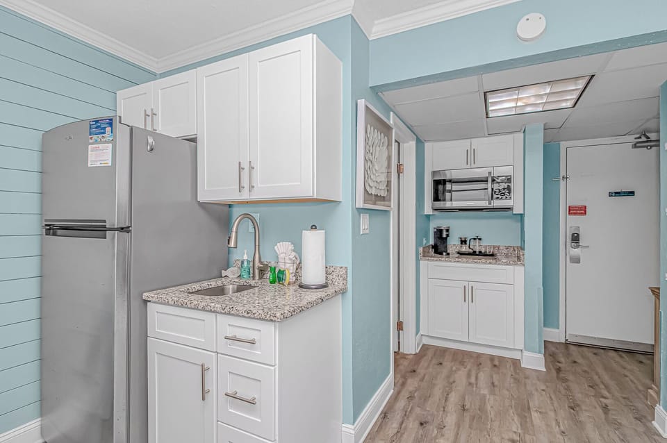 A simple kitchen setup with space to store groceries and prepare your favorite snacks.
