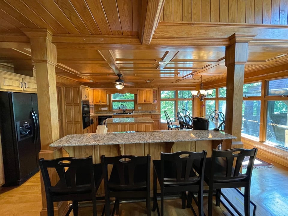 View of kitchen with bar seating and dining table. Previous appliances shown.