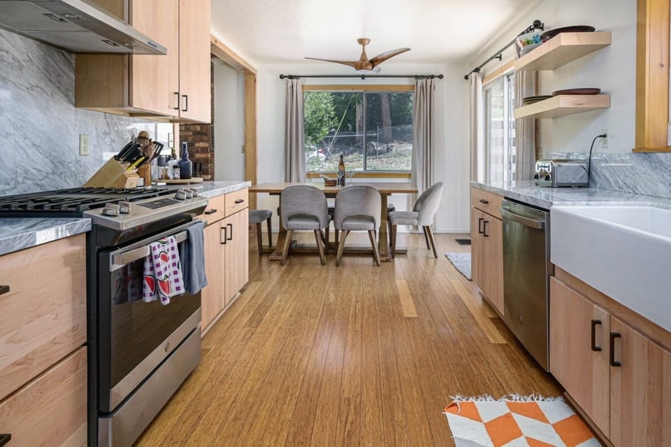 Open kitchen and dining space adjacent to outdoor deck.