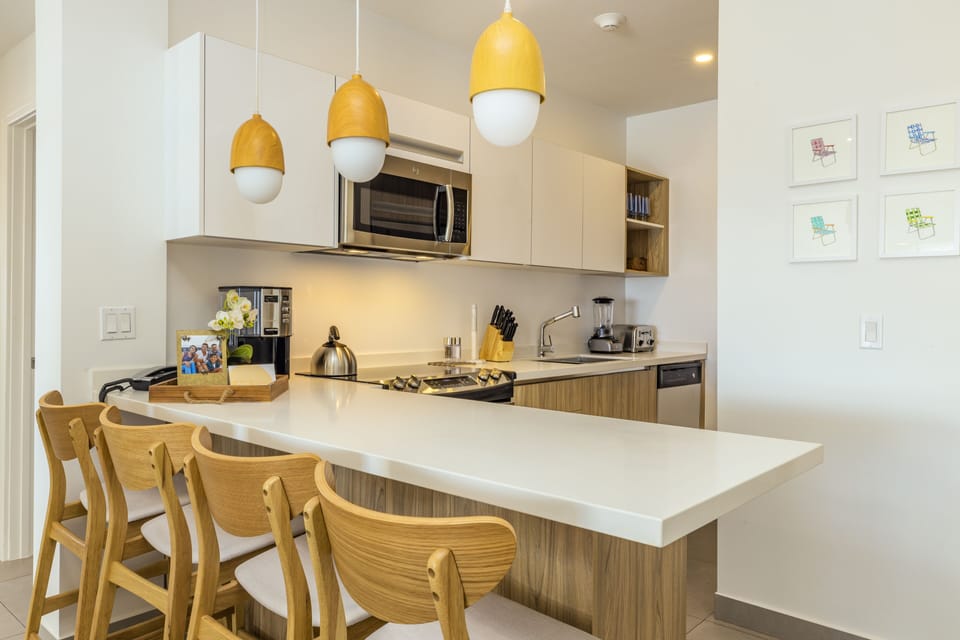 Gather with your group around the sleek breakfast bar in this bright, modern kitchen fully equipped with everything you need to prepare meals together and feel right at home.