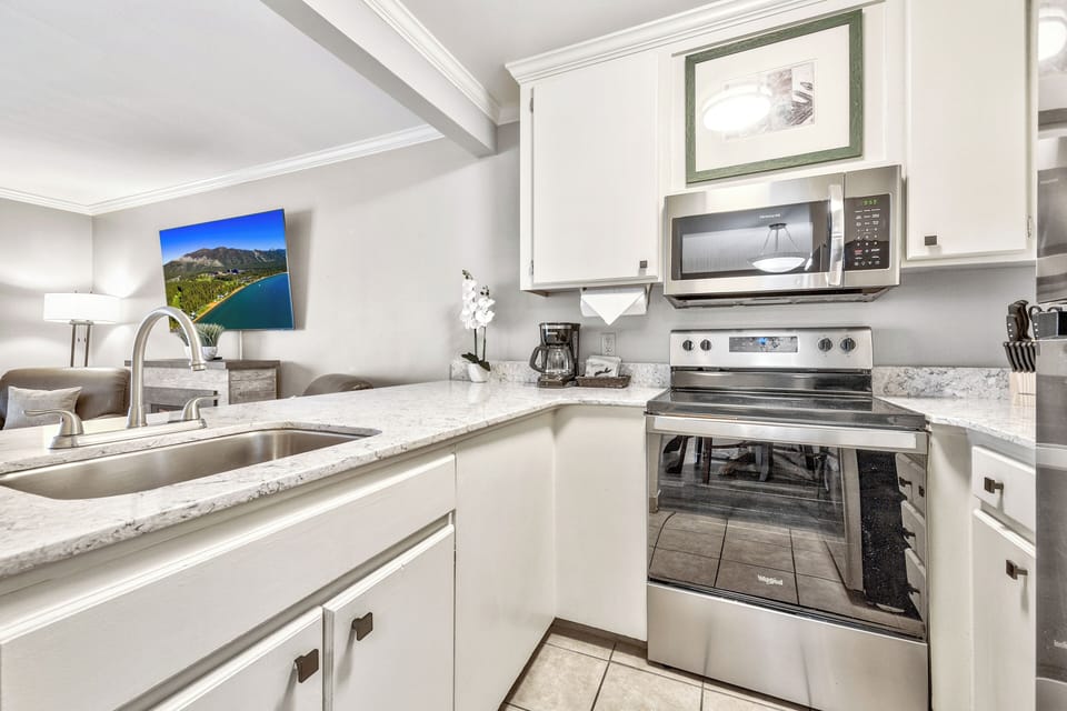 Prepare easy meals with full stove, microwave, and ample cabinetry.