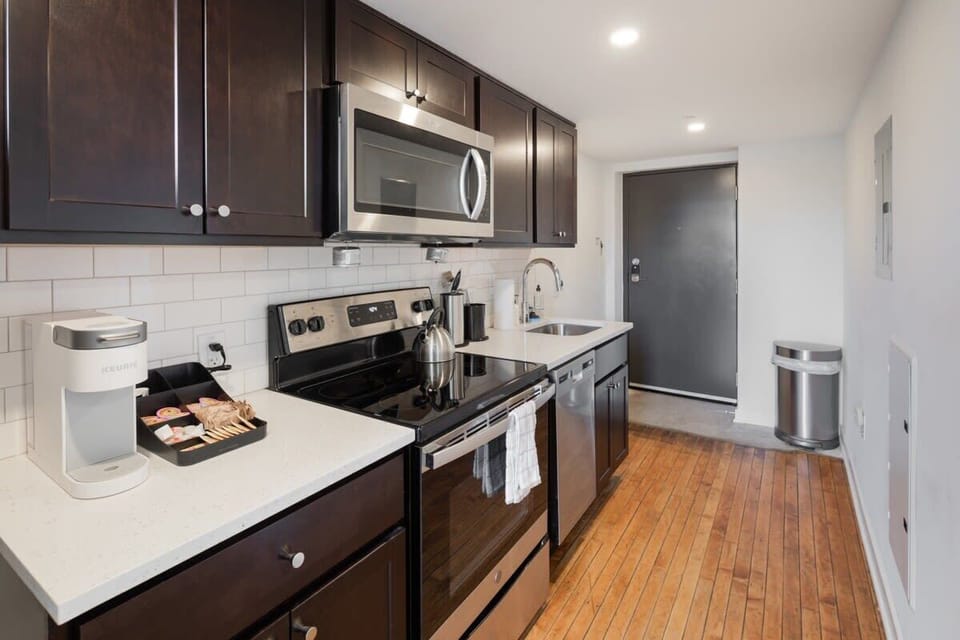 Enjoy home-cooked or the neighborhood's best takeout in this lovely kitchen with stainless steel appliances, a microwave, and a full-sized refrigerator