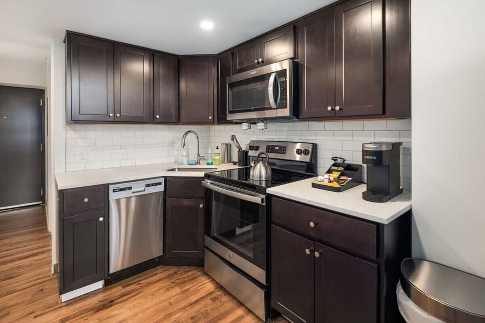 Enjoy home-cooked or the neighborhood's best takeout in this lovely kitchen with stainless steel appliances and a full-sized refrigerator