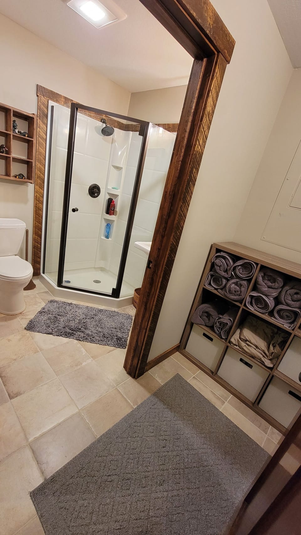 Downstairs bathroom with walk in shower and separate changing area and mirror. 