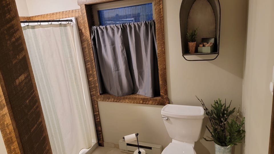 Upstairs bathroom with walk in shower.  Separate changing area and sink.  