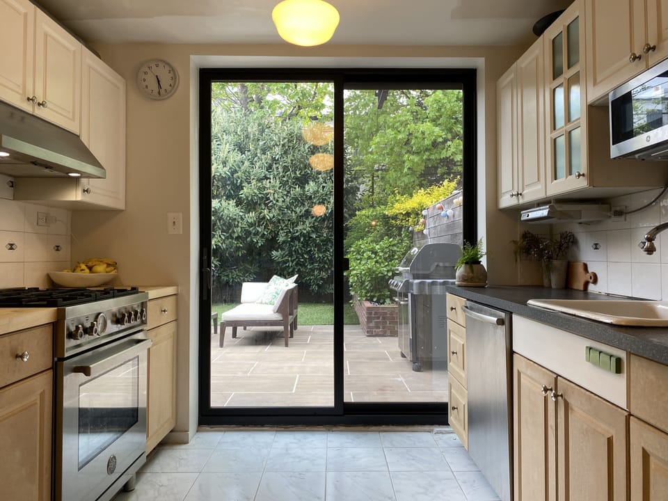 Ground floor kitchen with sliding door leading to garden