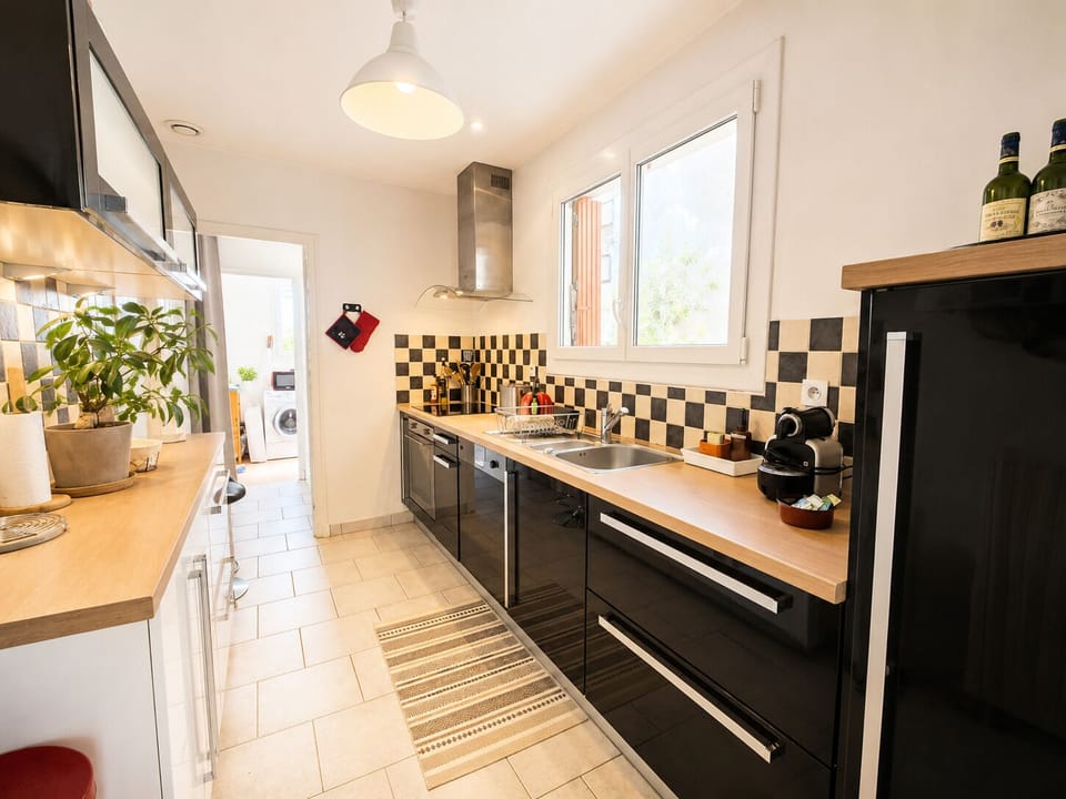 Fitted kitchen and access to the laundry room