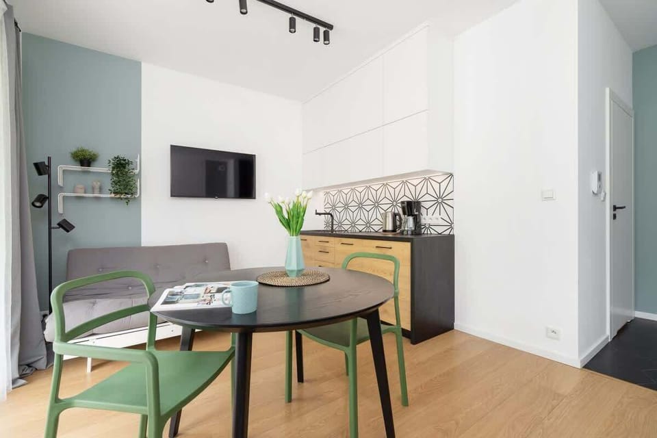 A living area adjacent to a bedroom with modern decor and functional use of space.