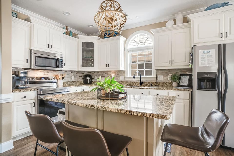 Spacious kitchen with granite island and modern stainless appliances