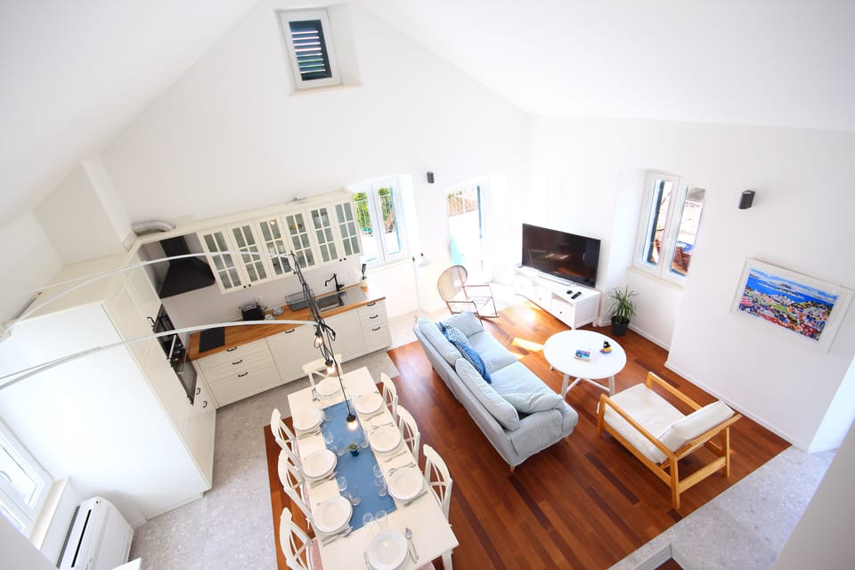Dining/living area with kitchen viewed from the Loft