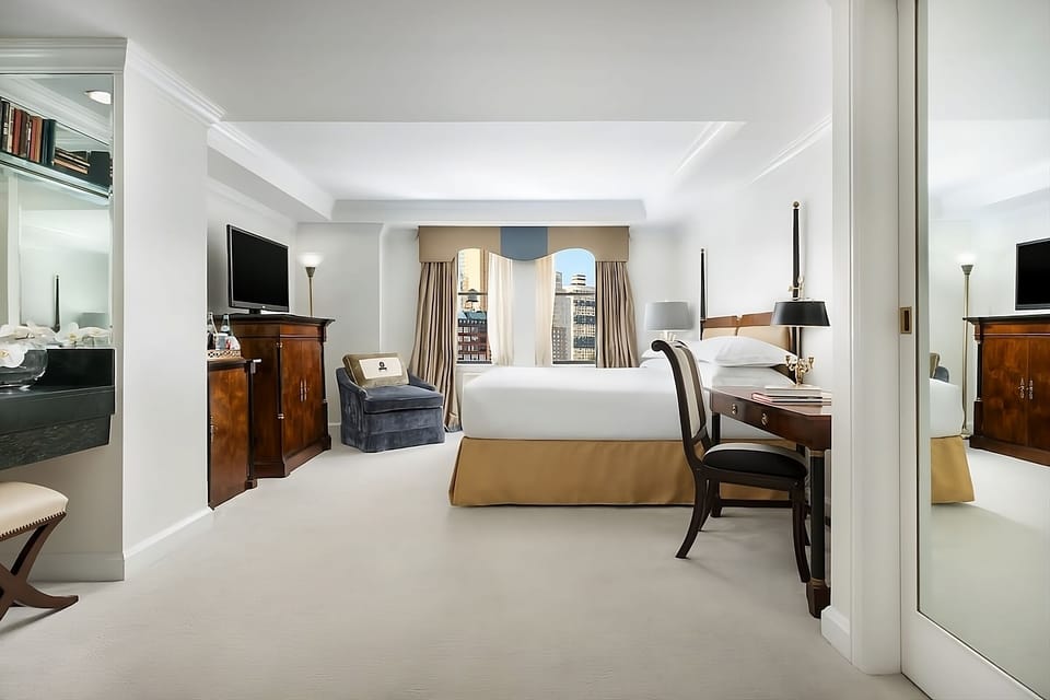 Step into a spacious retreat with desk and lounge chair.