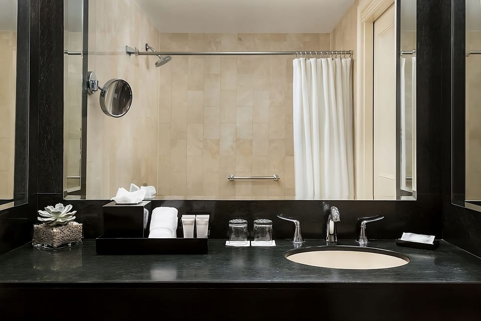 Refresh at the sleek vanity with spa-style amenities.