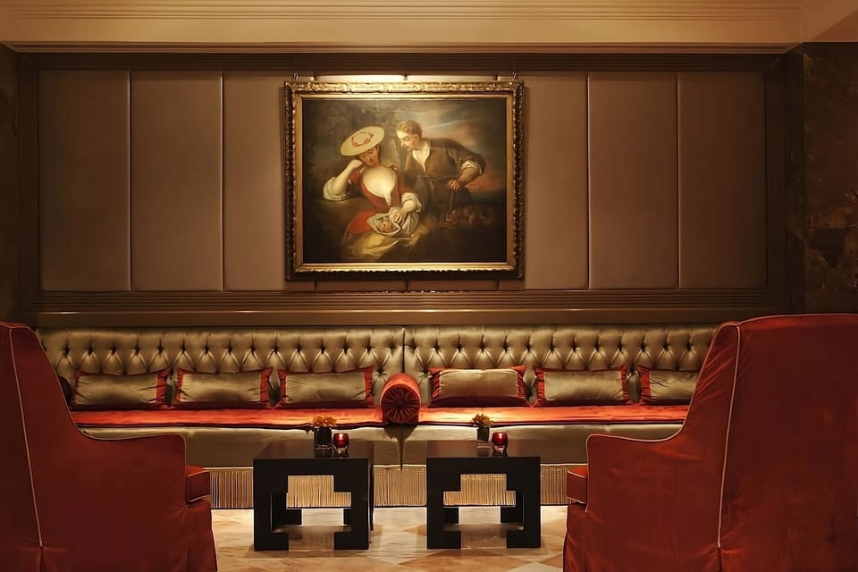Relax on tufted banquettes beneath classic art and mood lighting.