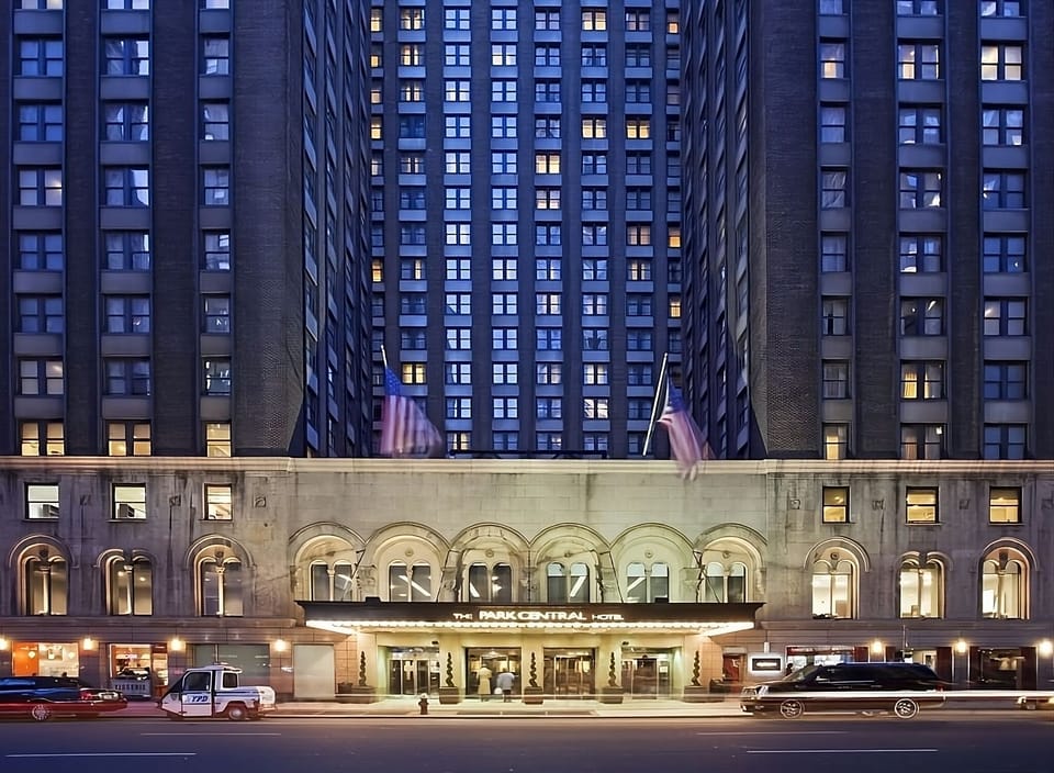 Arrive in style beneath glowing lights at the grand entrance