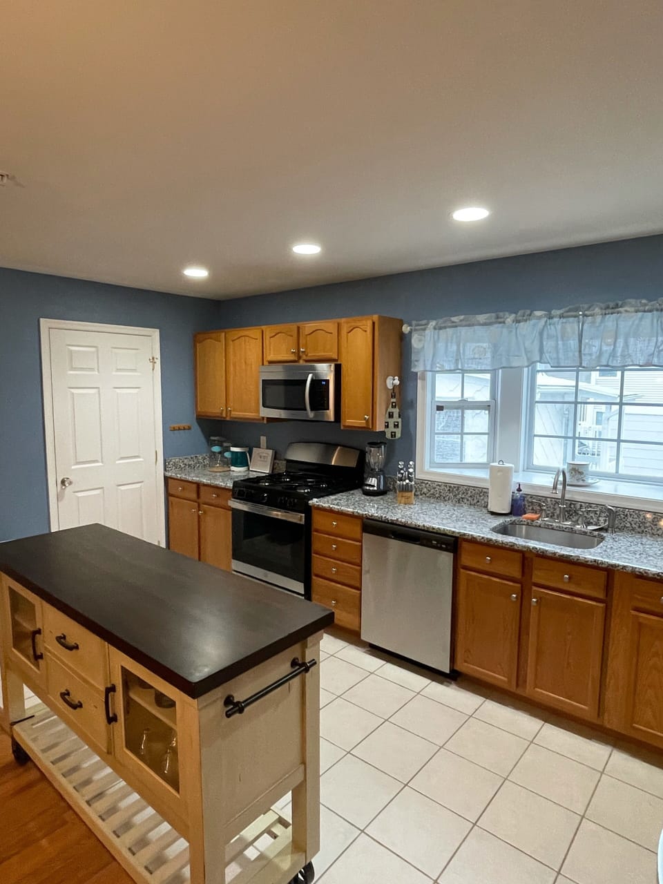 New SS Appliances and Island for cooking. Granite countertops and tiled floor. 