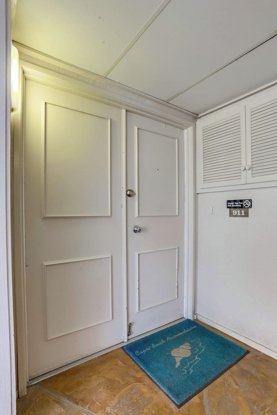 Front door condo entrance with key locks. A fob is needed to enter Capri by the Sea and get up the elevator to the 9th floor.