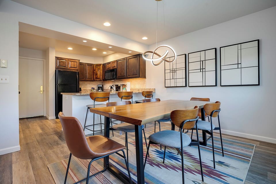 Gather around this stylish dining table where your group can share meals and create memories in this modern open-concept space.