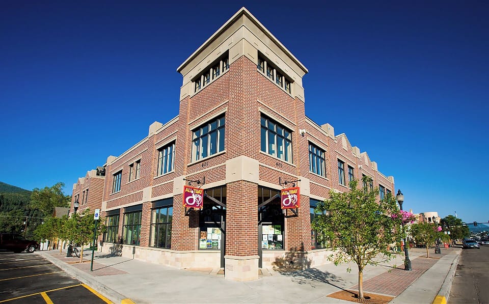 Historic brick building featuring distinctive architectural details and retail spaces in the surrounding neighborhood.