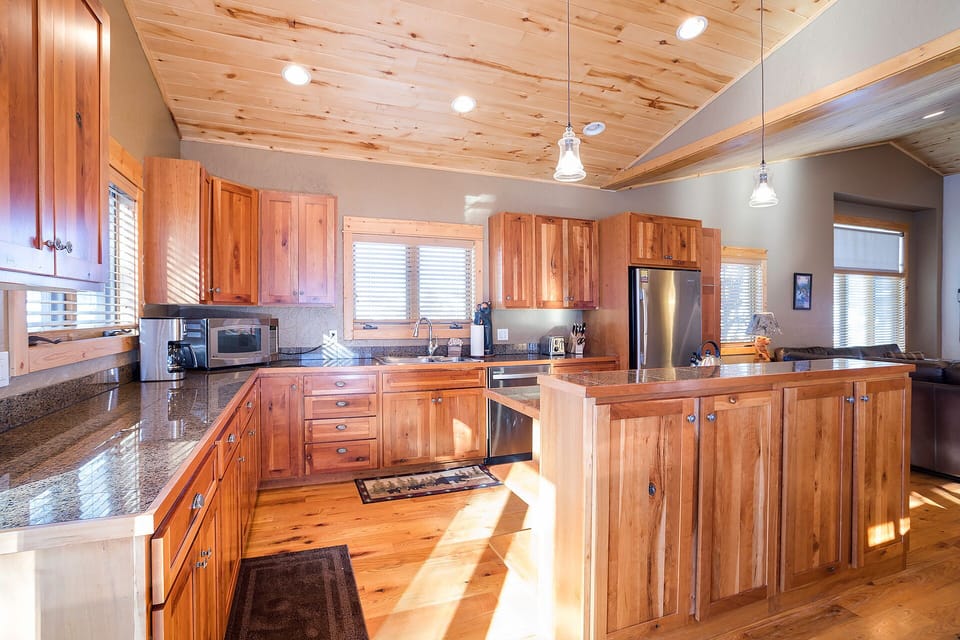 Step into your gourmet kitchen with rich wood cabinetry, granite countertops, and stainless steel appliances—perfect for creating memorable meals together.
