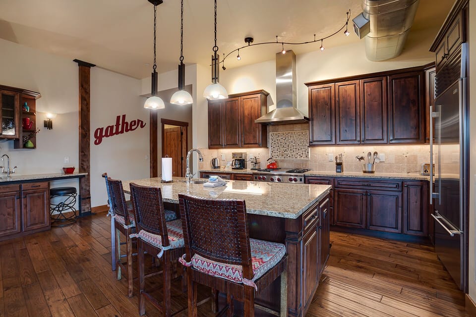 Gather around this stunning kitchen island where culinary adventures await with professional-grade appliances and warm wood finishes.