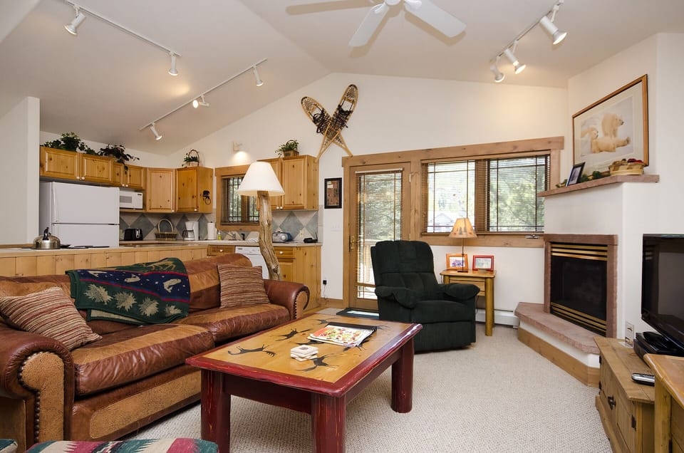 Settle into your cozy mountain retreat where rustic charm meets comfort - sink into the leather sofa by the fireplace after exploring.