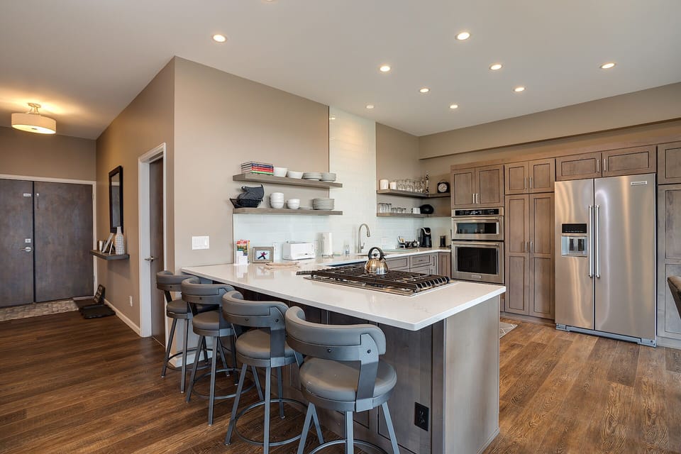 Cook gourmet meals in this sleek modern kitchen featuring quartz countertops, stainless appliances, and a spacious island perfect for entertaining.