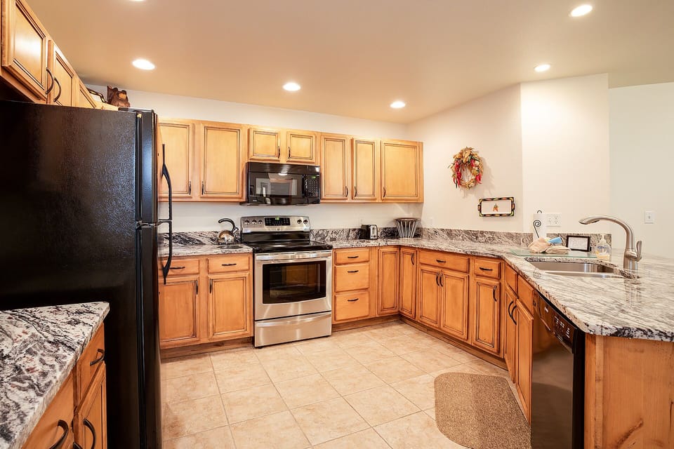 Your fully equipped kitchen awaits with granite countertops, stainless appliances, and ample cabinet space for preparing memorable meals together.