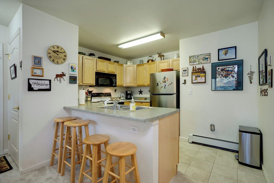 Your cozy kitchen invites casual meals at the breakfast bar, complete with full appliances and charming local artwork.