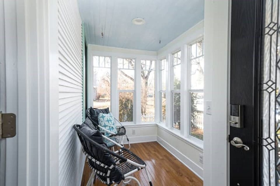Enjoy morning coffee on sunny enclosed porch as neighbors walking dogs stroll by