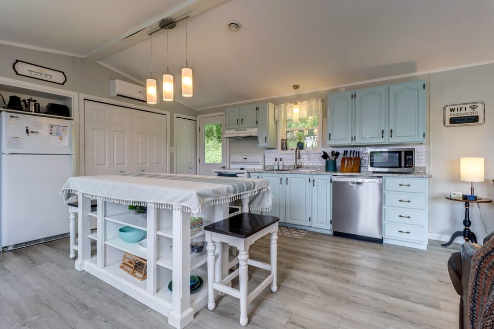 Kitchen area.  Island with stools to sit at.