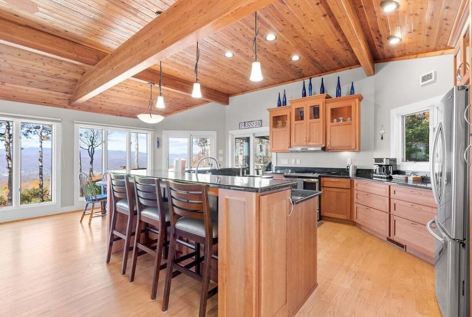 Barstools along the kitchen island provide additional seating.