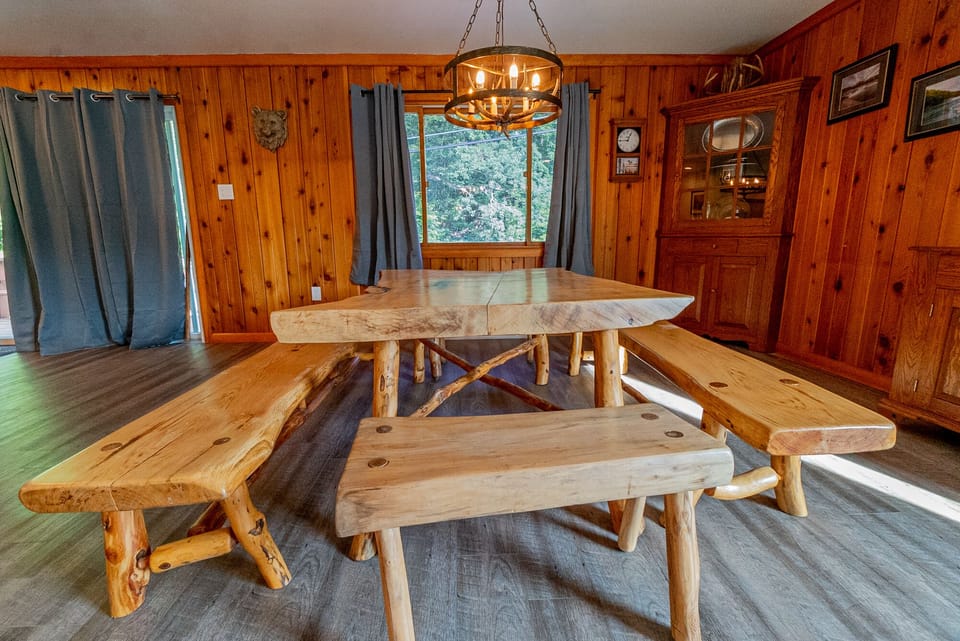 Dining Area - Rustic and nature inspired wooded table and chairs for 10-12 people.
