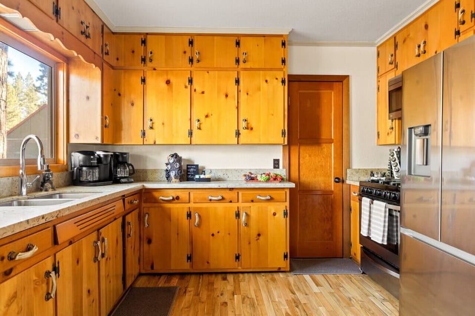 Fully stocked kitchen for every cooking need, featuring stainless steel appliances.