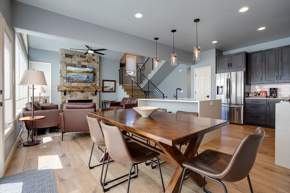 Gather around this handsome dining table while your chef creates magic in the gourmet kitchen behind you.