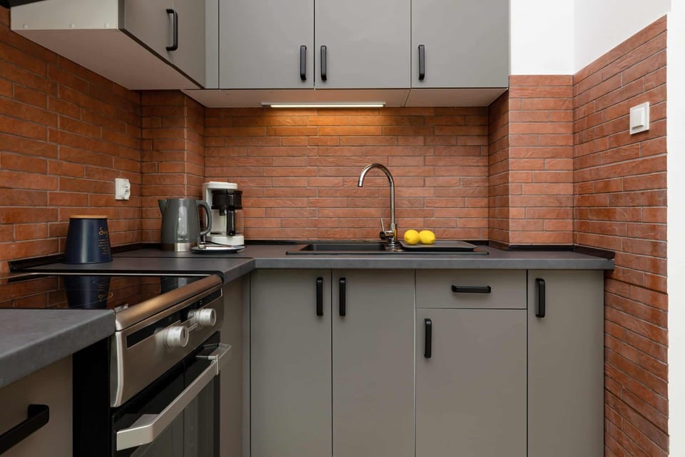 A view of kitchen essentials, including a kettle and coffee mug on the countertop, adding a homey feel.