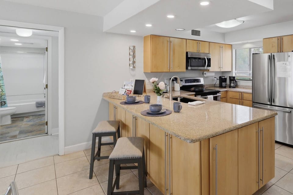 Modern kitchen with spacious breakfast bar seating — fully equipped for cooking, dining, and gathering with ease.