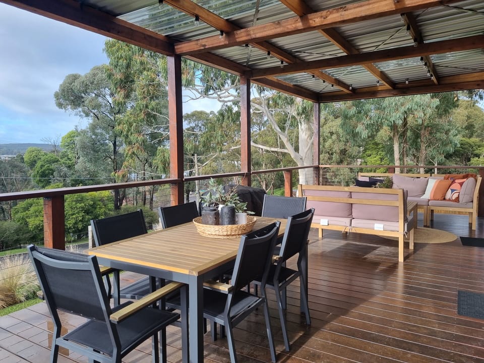 Front verandah with views, a lounge seating area, BBQ and outdoor table for six 