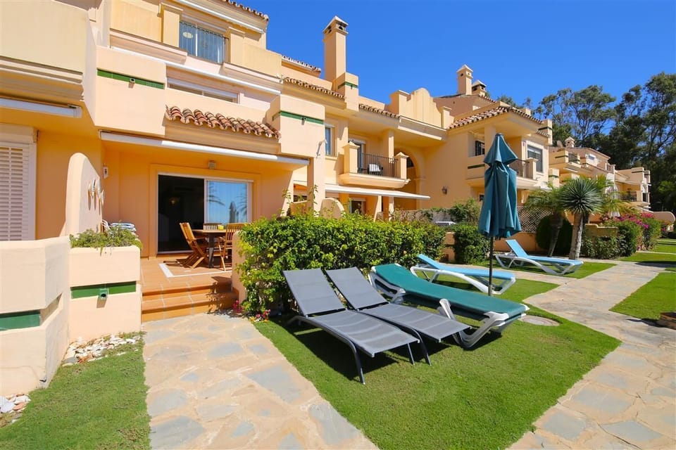 Terrace and gardens with sun loungers available for guests