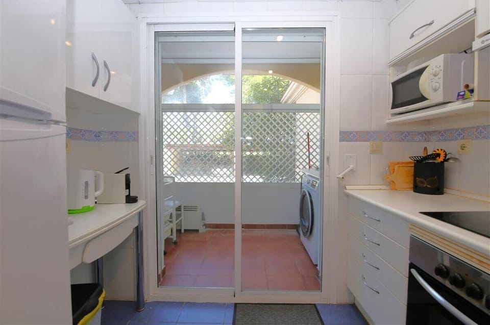 Another view of the kitchen with laundry room to the rear