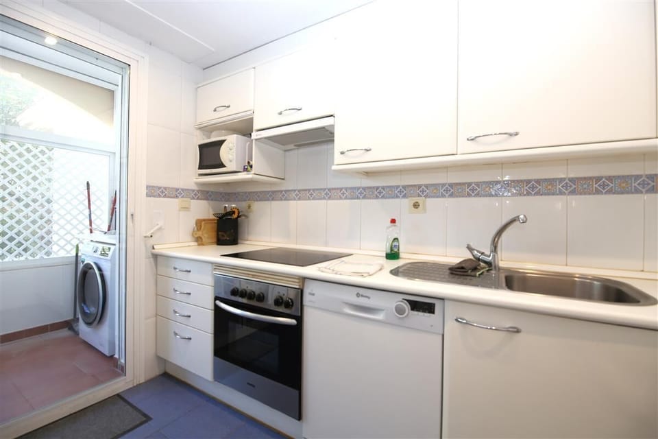 Modern and bright kitchen is equipped with all the appliances
