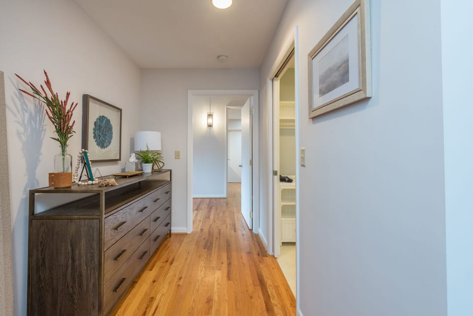 Main floor primary bedroom with king-size bed and en suite bathroom with walk-in shower